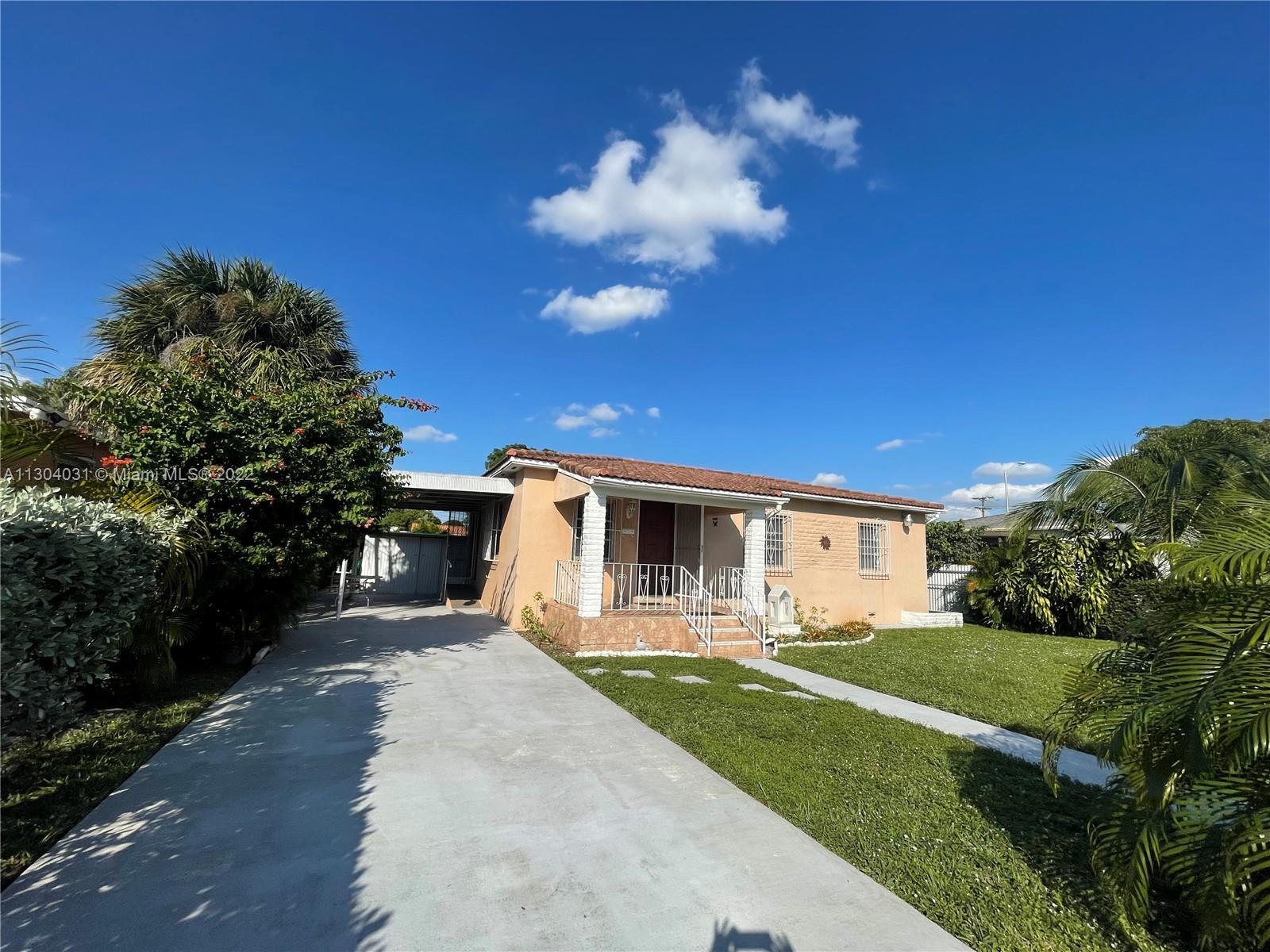 231 West 43rd Street Hialeah, FL 33012 - Photo 3 of 14 a front view of a house with a yard