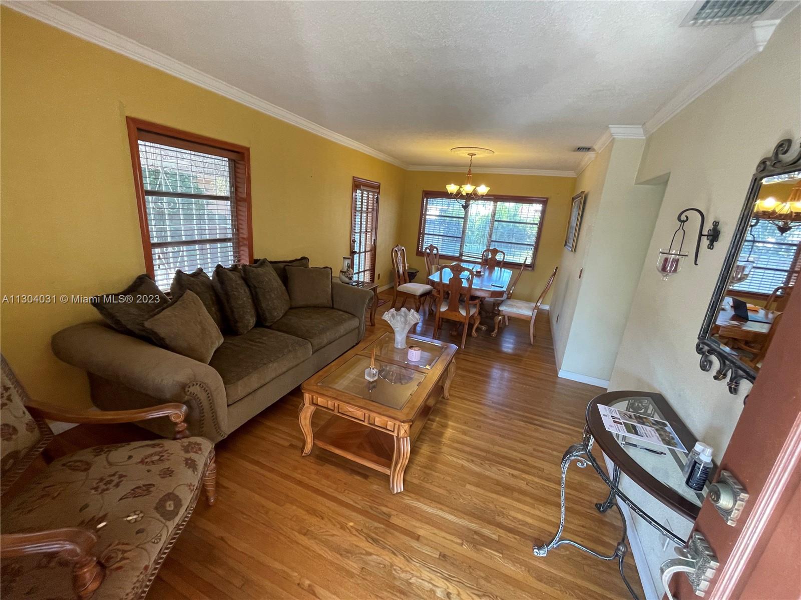 231 West 43rd Street Hialeah, FL 33012 - Photo 4 of 14 a living room with furniture and a wooden floor
