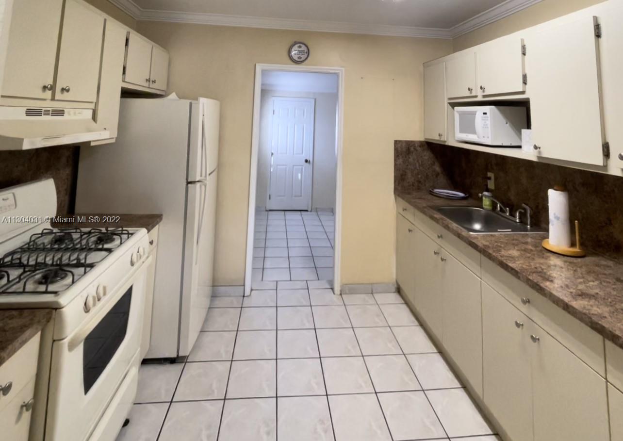 231 West 43rd Street Hialeah, FL 33012 - Photo 5 of 14 a kitchen with stainless steel appliances a sink a stove a refrigerator and cabinets