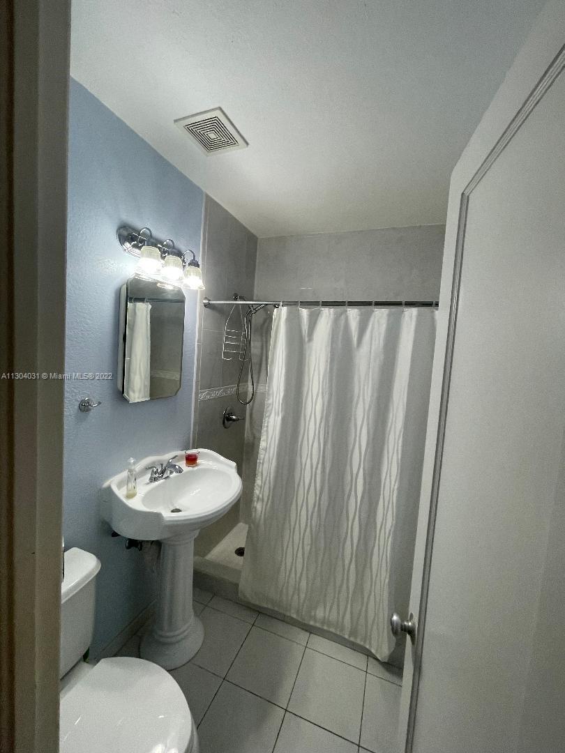 231 West 43rd Street Hialeah, FL 33012 - Photo 7 of 14 a bathroom with a sink toilet and mirror
