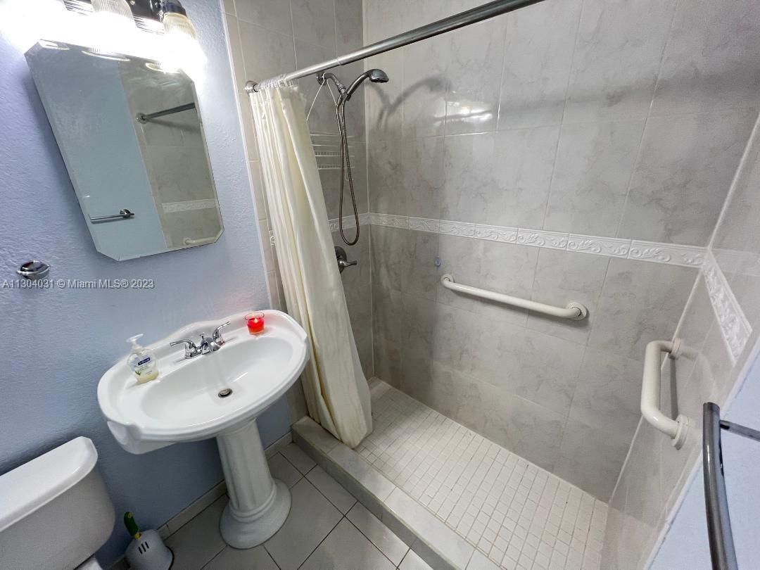 231 West 43rd Street Hialeah, FL 33012 - Photo 8 of 14 a bathroom with a sink toilet and shower