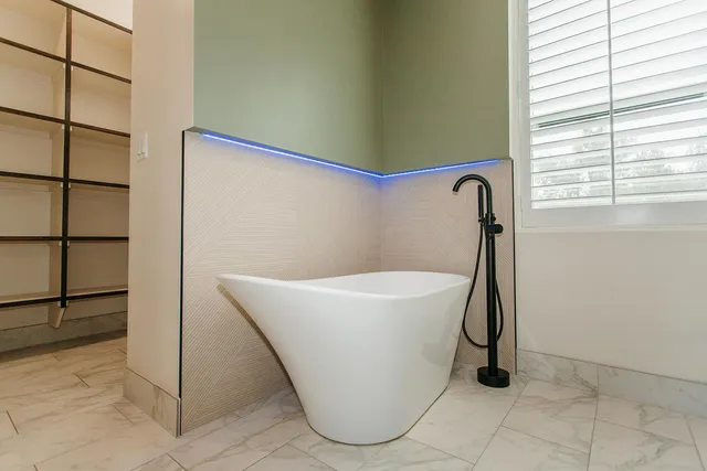 a white bath tub sitting in a bathroom