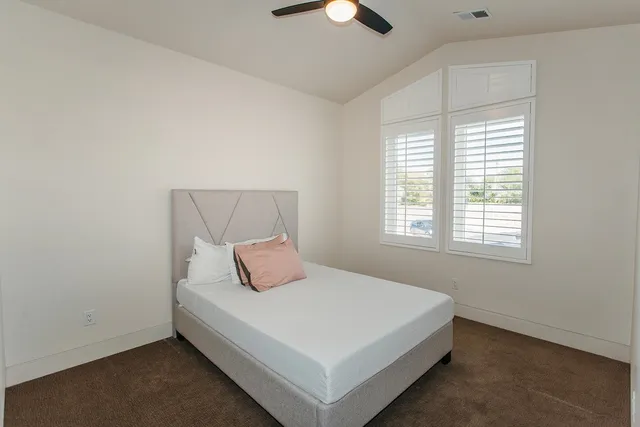 a bedroom with a bed and a window