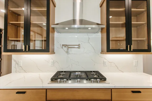 a stove top oven sitting inside of a kitchen