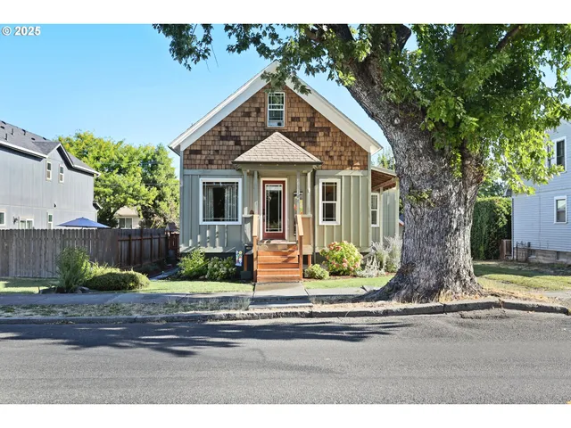 a view of house and tree in the background