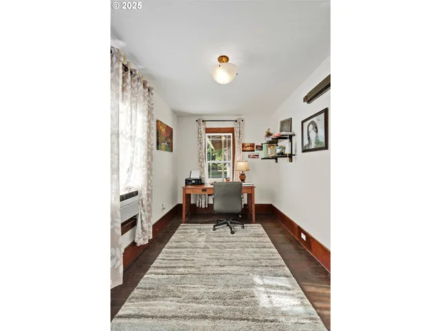 a hallway with a white couches chair and white walls