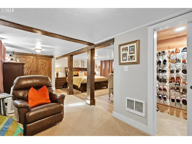 a living room with furniture and a floor to ceiling window