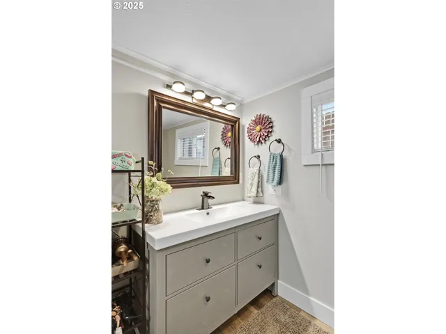 a bathroom with a double vanity sink mirror and