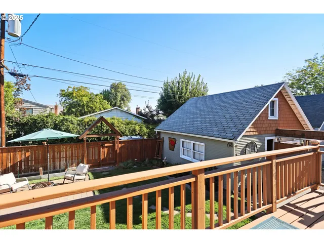 a view of a house with a wooden fence