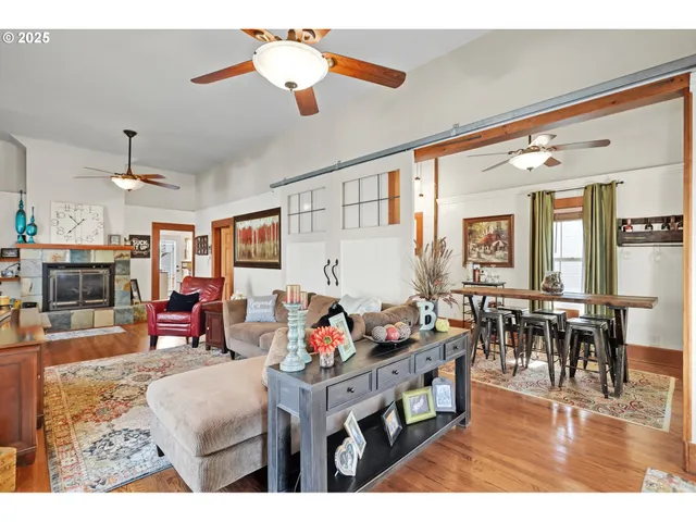 a living room with furniture a dining table and a fireplace