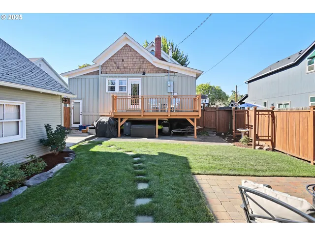 a front view of a house with a garden and patio