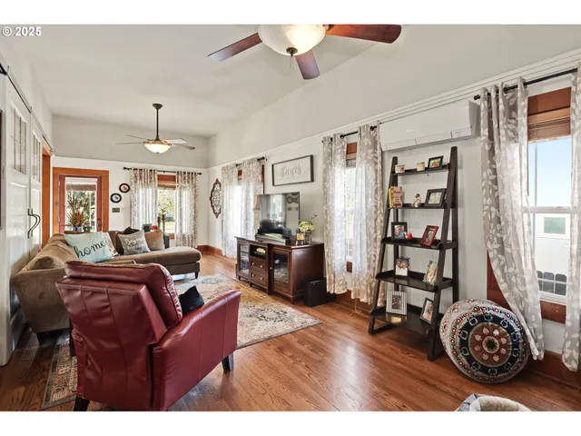 a living room with furniture a chandelier and a window