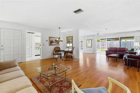 a living room with furniture and a wooden floor