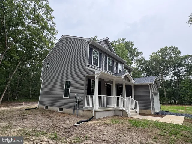 a house that has a tree in front of it