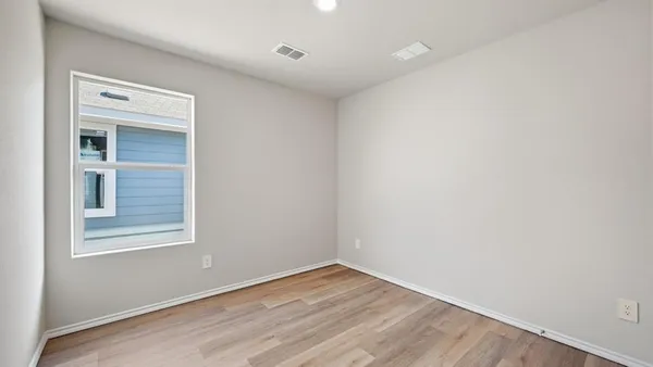 a view of room with wooden floor