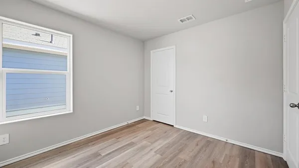 a bathroom with a granite countertop bathtub shower sink vanity mirror and toilet