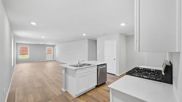 a kitchen with stainless steel appliances a sink stove and cabinets