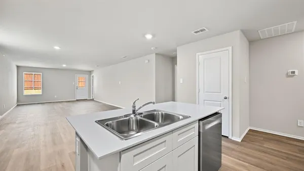 a kitchen with a stove and white cabinets