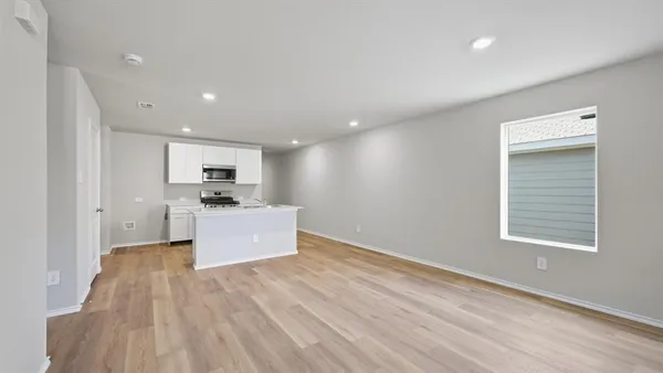 a kitchen with white cabinets and black appliances