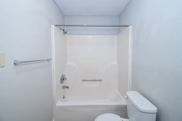 a bathroom with a shower and toilet