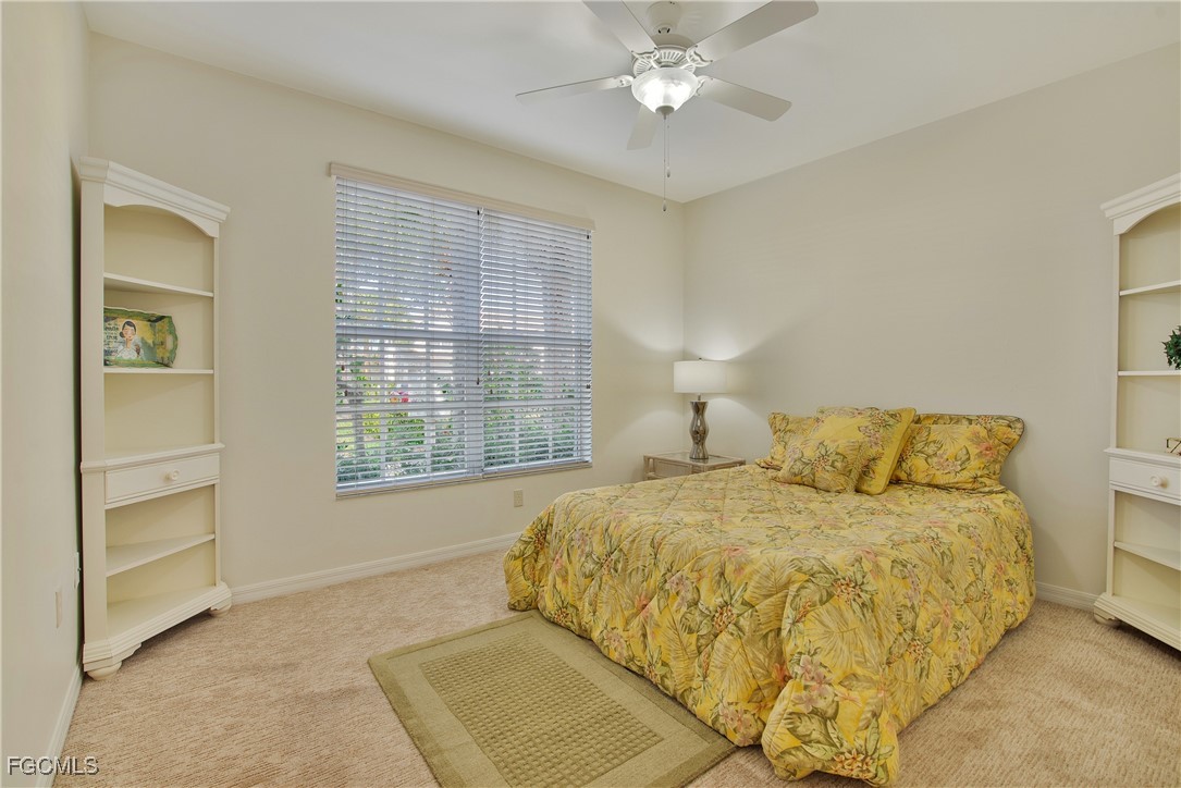 9631 Hemingway Lane, Unit 3610 Fort Myers, FL 33913 - Photo 11 of 21 a bedroom with a large bed and a chandelier