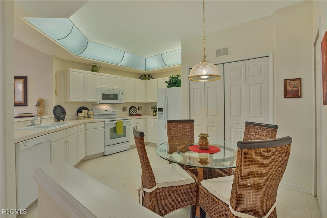 9631 Hemingway Lane, Unit 3610 Fort Myers, FL 33913 - Photo 5 of 21 a view of kitchen with stainless steel appliances dining table and chairs