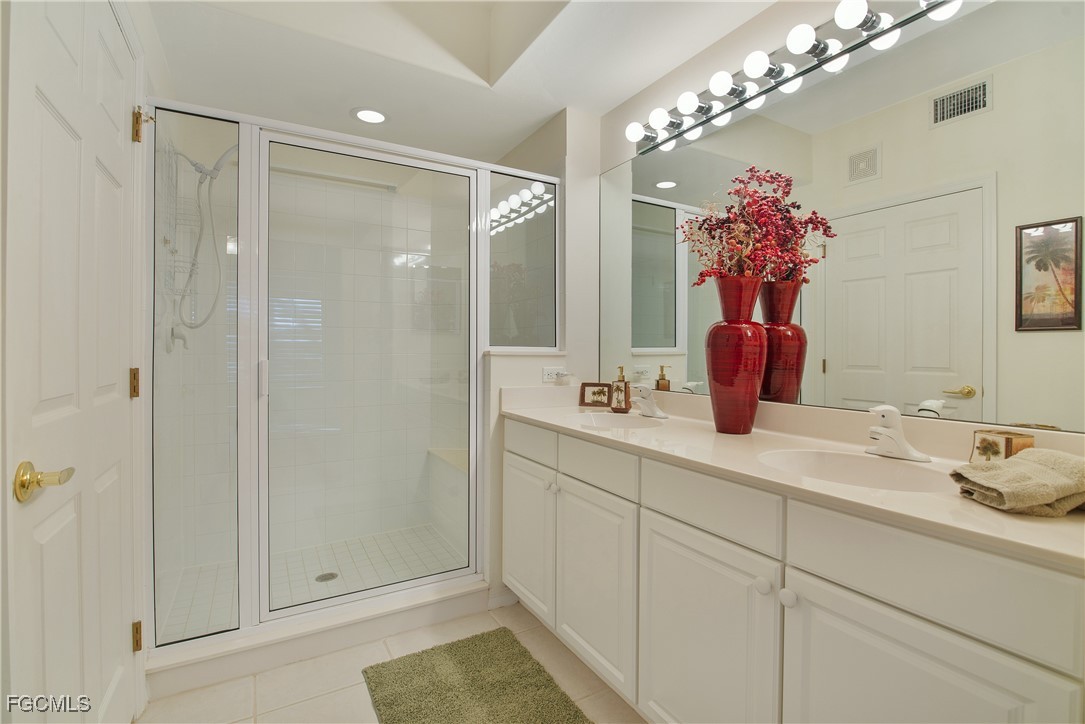 9631 Hemingway Lane, Unit 3610 Fort Myers, FL 33913 - Photo 10 of 21 a bathroom with a shower sink and mirror