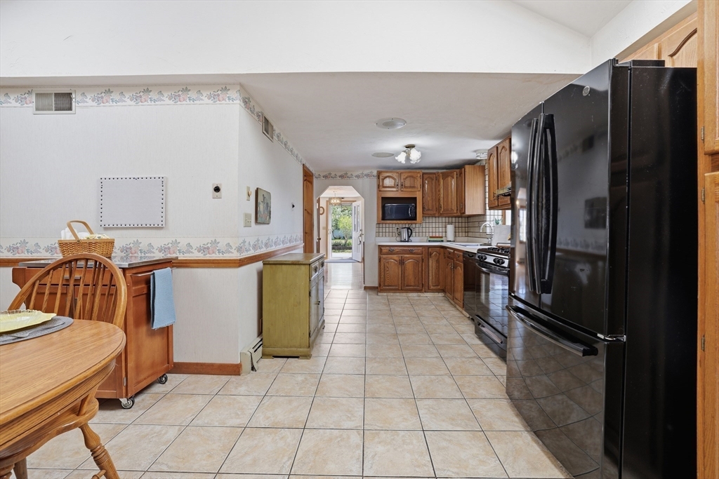 7 Swift Avenue Wareham, MA 02571 - Photo 9 of 42 a kitchen with granite countertop a refrigerator and a stove top oven