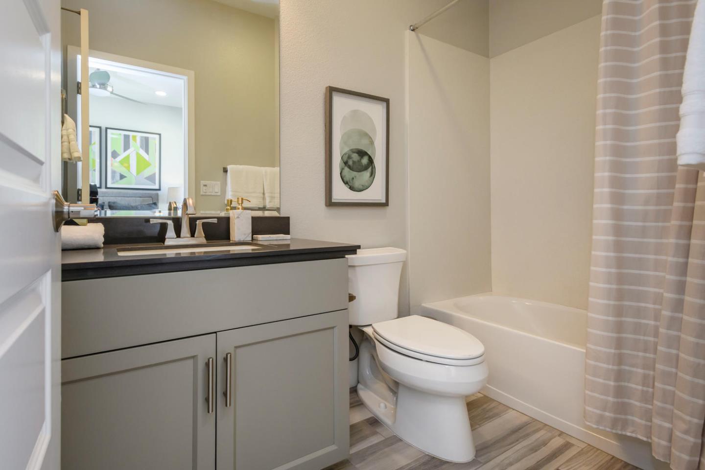 2864 Baze Road San Mateo, CA 94403 - Photo 18 of 20 a bathroom with a toilet a sink and a mirror