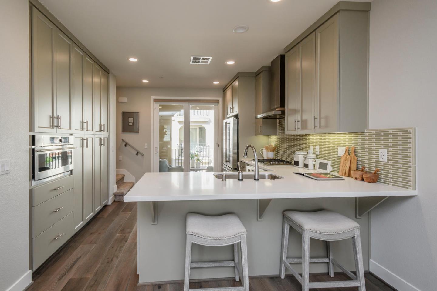 2864 Baze Road San Mateo, CA 94403 - Photo 7 of 20 a kitchen with stainless steel appliances granite countertop a table chairs sink and cabinets