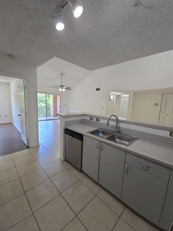 12172 St Andrews Place, Unit 305 Miramar, FL 33025 - Photo 15 of 35 a large kitchen with granite countertop a sink and white cabinets