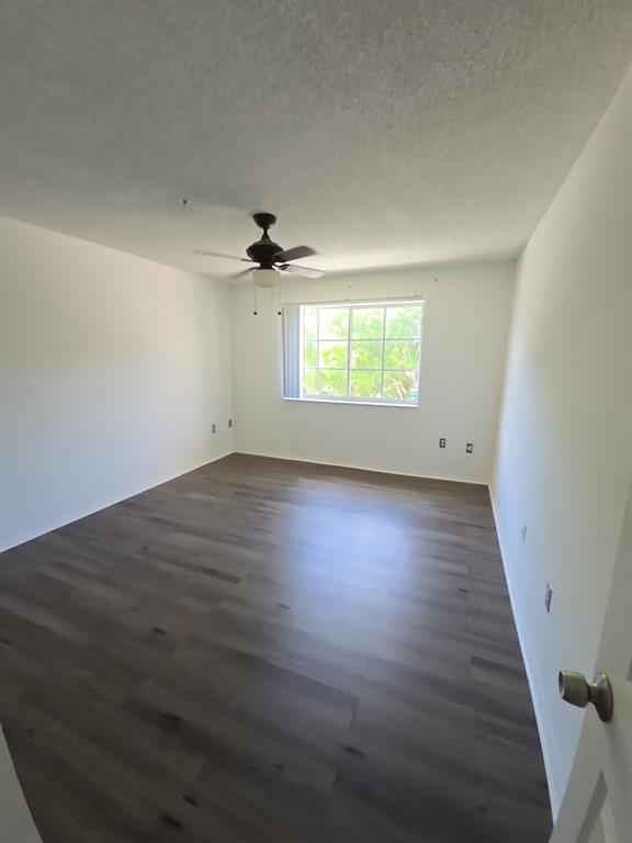 12172 St Andrews Place, Unit 305 Miramar, FL 33025 - Photo 16 of 35 an empty room with wooden floor and windows