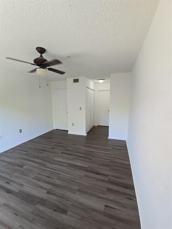 12172 St Andrews Place, Unit 305 Miramar, FL 33025 - Photo 18 of 35 a view of a room with wooden floor and a ceiling fan
