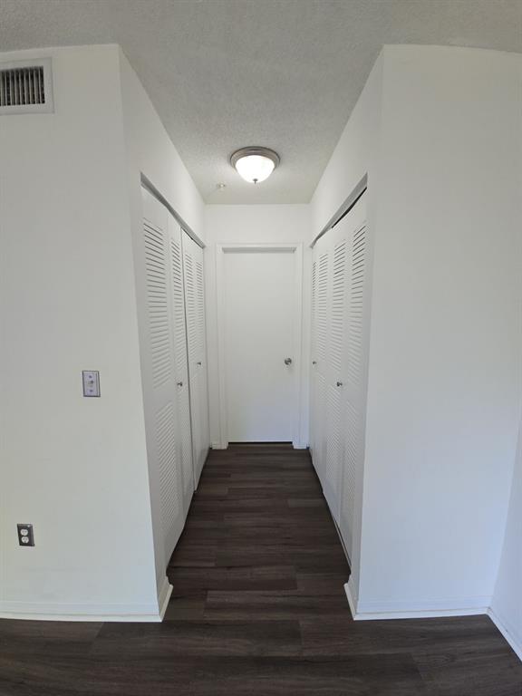 12172 St Andrews Place, Unit 305 Miramar, FL 33025 - Photo 19 of 35 a view of a hallway with wooden floor