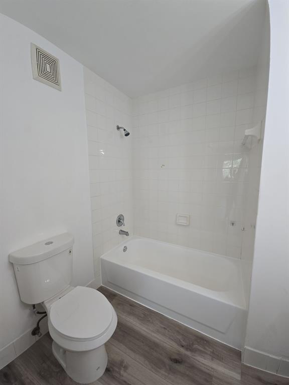12172 St Andrews Place, Unit 305 Miramar, FL 33025 - Photo 27 of 35 a bathroom with a toilet and a bath tub