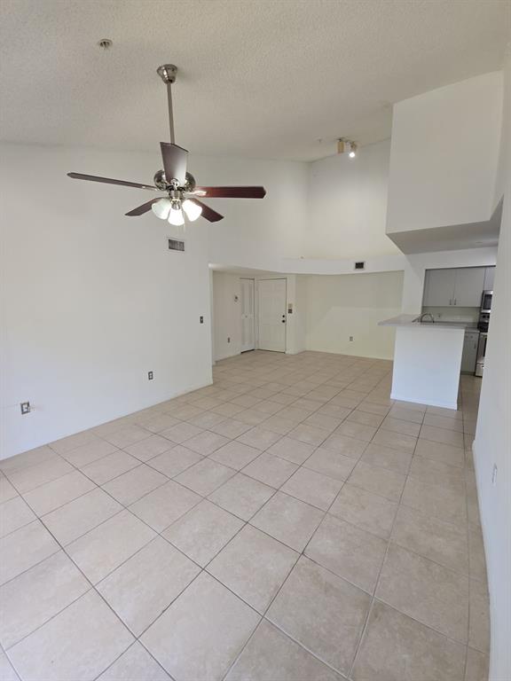 12172 St Andrews Place, Unit 305 Miramar, FL 33025 - Photo 9 of 35 a view of a room with a chandelier fan and windows