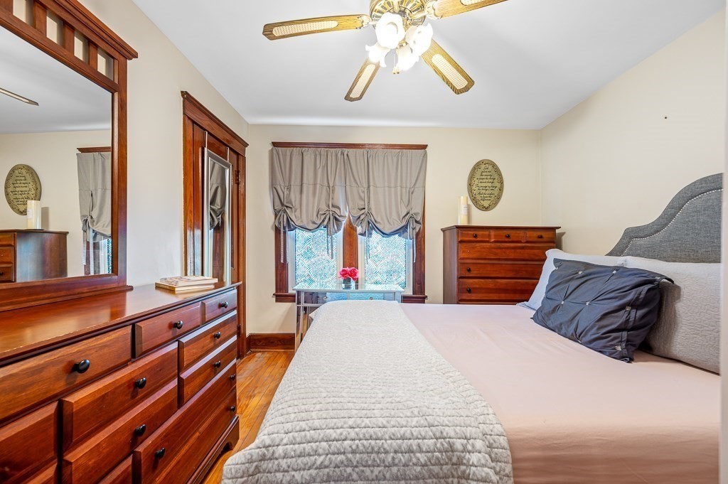 18 Prentice Street Worcester, MA 01604 - Photo 12 of 42 a bedroom with a bed and a chandelier