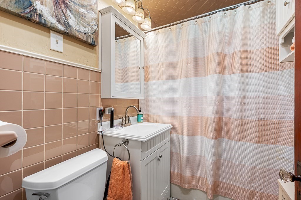 18 Prentice Street Worcester, MA 01604 - Photo 14 of 42 a bathroom with a sink a toilet and shower curtain