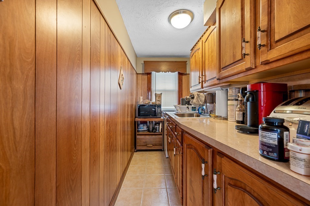 18 Prentice Street Worcester, MA 01604 - Photo 17 of 42 a kitchen with stainless steel appliances granite countertop a sink and cabinets