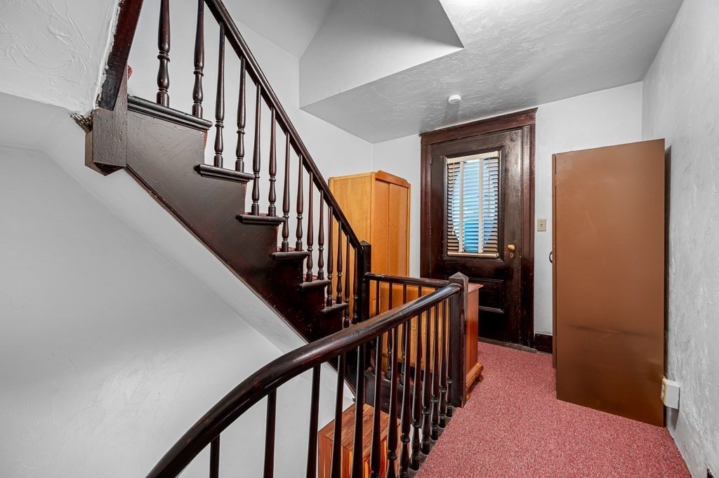 18 Prentice Street Worcester, MA 01604 - Photo 28 of 42 a view of staircase with lots of frames on wall and wooden floor