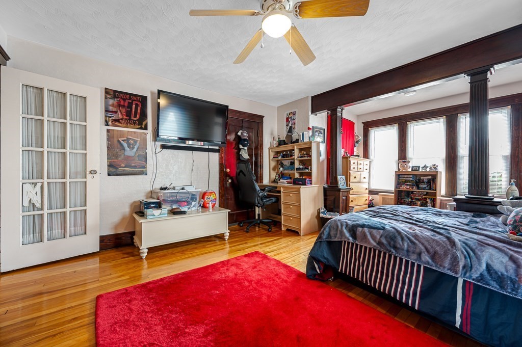 18 Prentice Street Worcester, MA 01604 - Photo 9 of 42 a bedroom with a bed and a flat screen tv