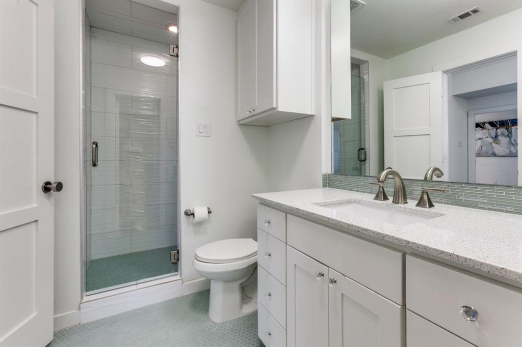 4206 Manning Lane Dallas, TX 75220 - Photo 27 of 35 a bathroom with a granite countertop sink a toilet and shower