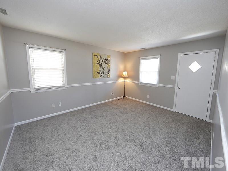 5912 Meadowbrook Road Raleigh, NC 27603 - Photo 2 of 12 an empty room with windows and closet