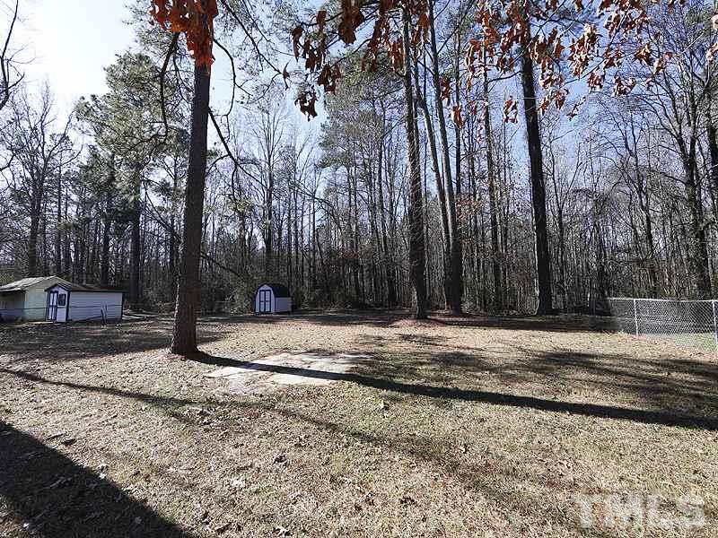 5912 Meadowbrook Road Raleigh, NC 27603 - Photo 11 of 12 a view of a backyard with large trees