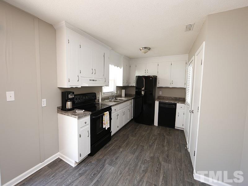 5912 Meadowbrook Road Raleigh, NC 27603 - Photo 4 of 12 a kitchen with stainless steel appliances a refrigerator and a stove top oven