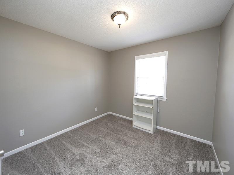 5912 Meadowbrook Road Raleigh, NC 27603 - Photo 9 of 12 a view of an empty room with a window