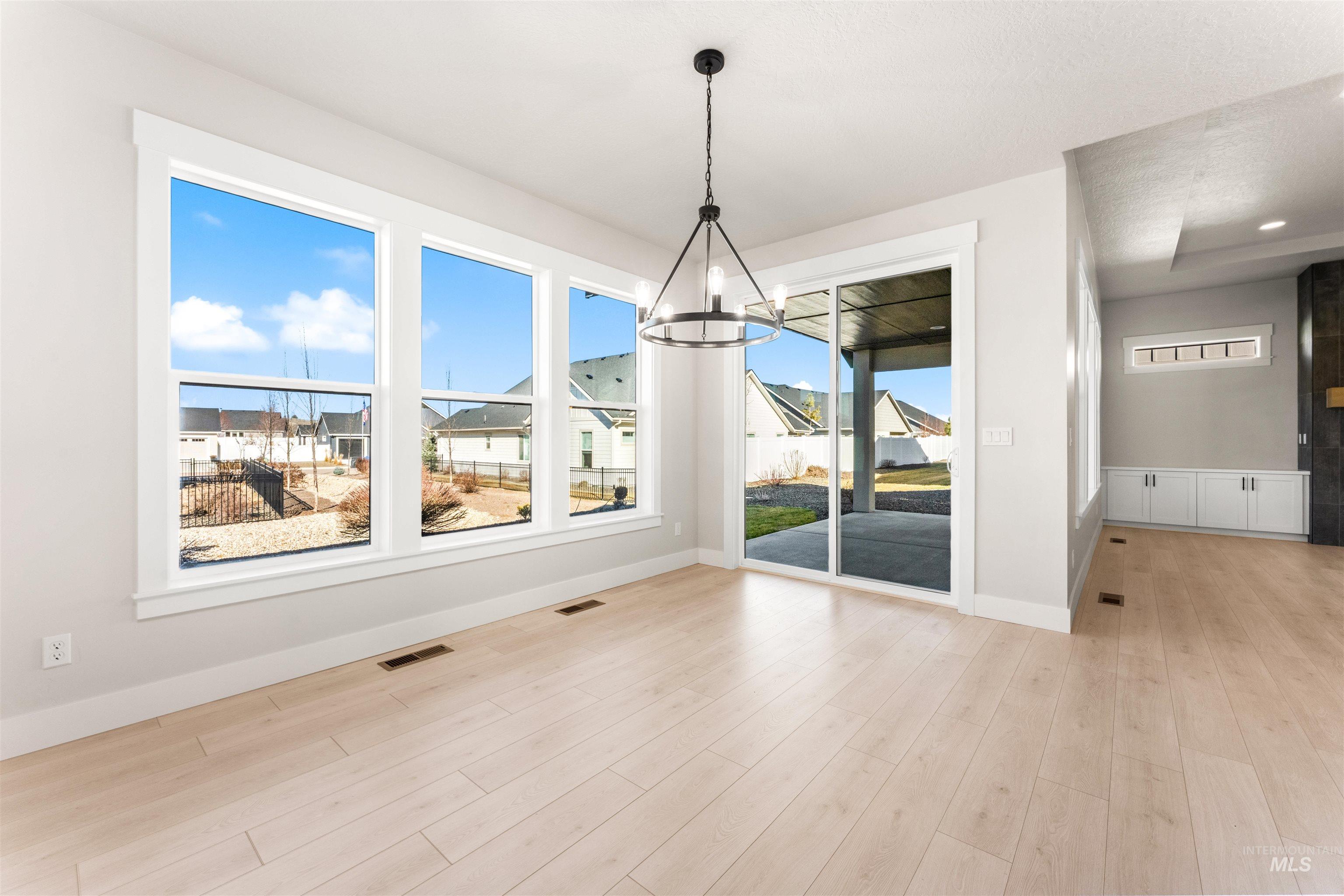 8084 Tandy Cv Street Middleton, ID 83644 - Photo 15 of 46 Unfurnished dining area with hanging lights and light wood-type flooring