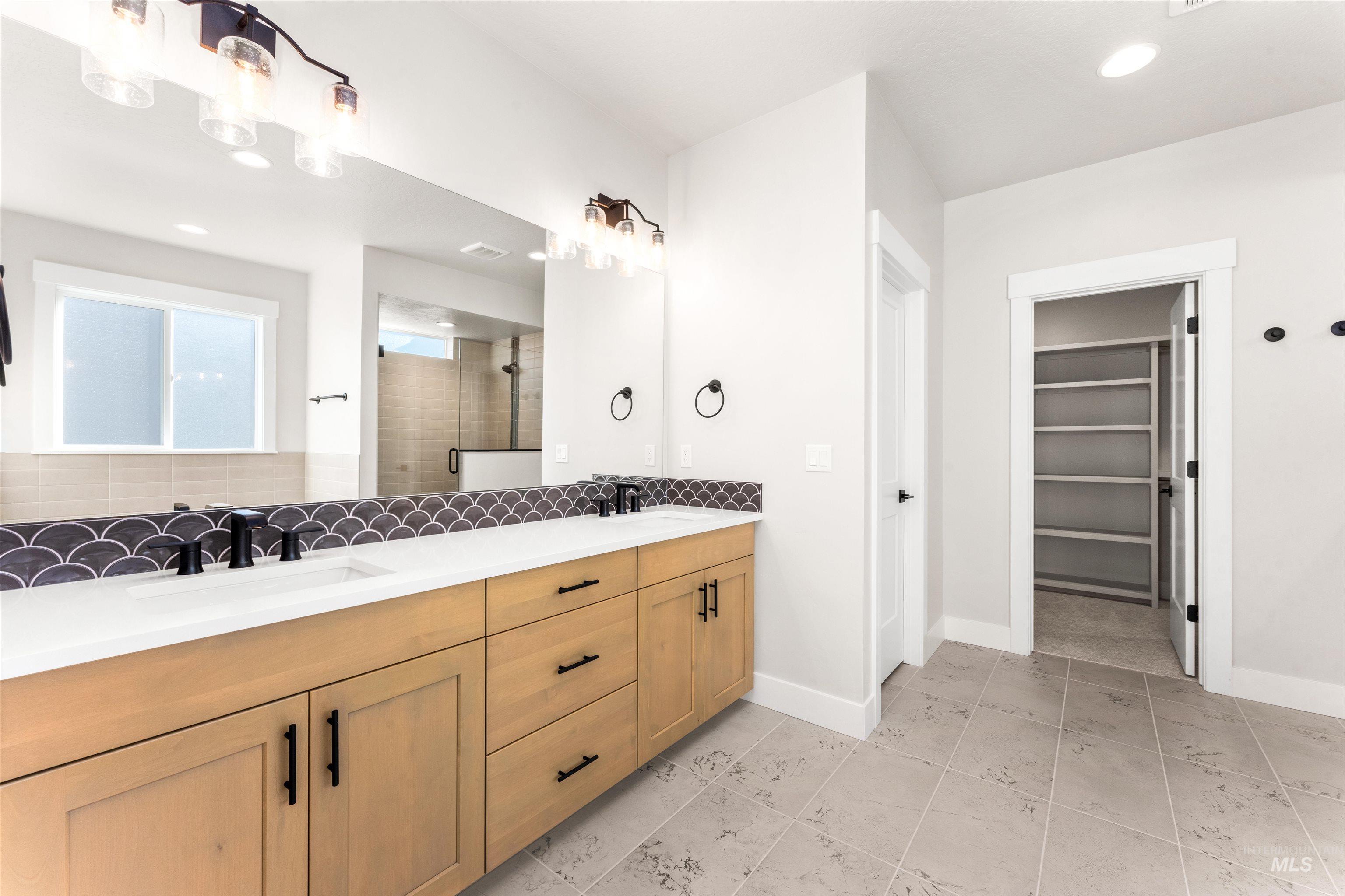 8084 Tandy Cv Street Middleton, ID 83644 - Photo 18 of 46 Bathroom featuring a stall shower, double vanity, recessed lighting, a spacious closet, and backsplash