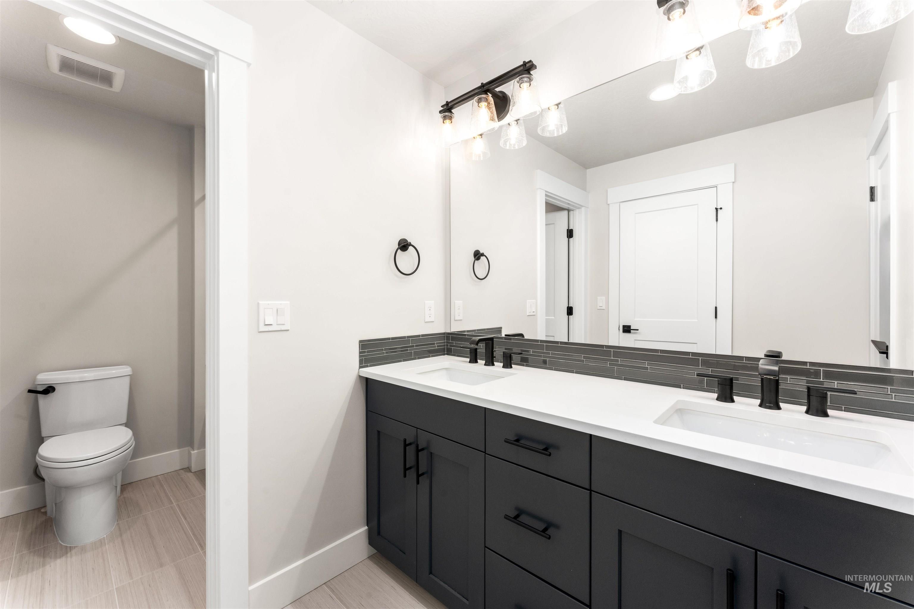 8084 Tandy Cv Street Middleton, ID 83644 - Photo 31 of 46 Bathroom with baseboards and double vanity