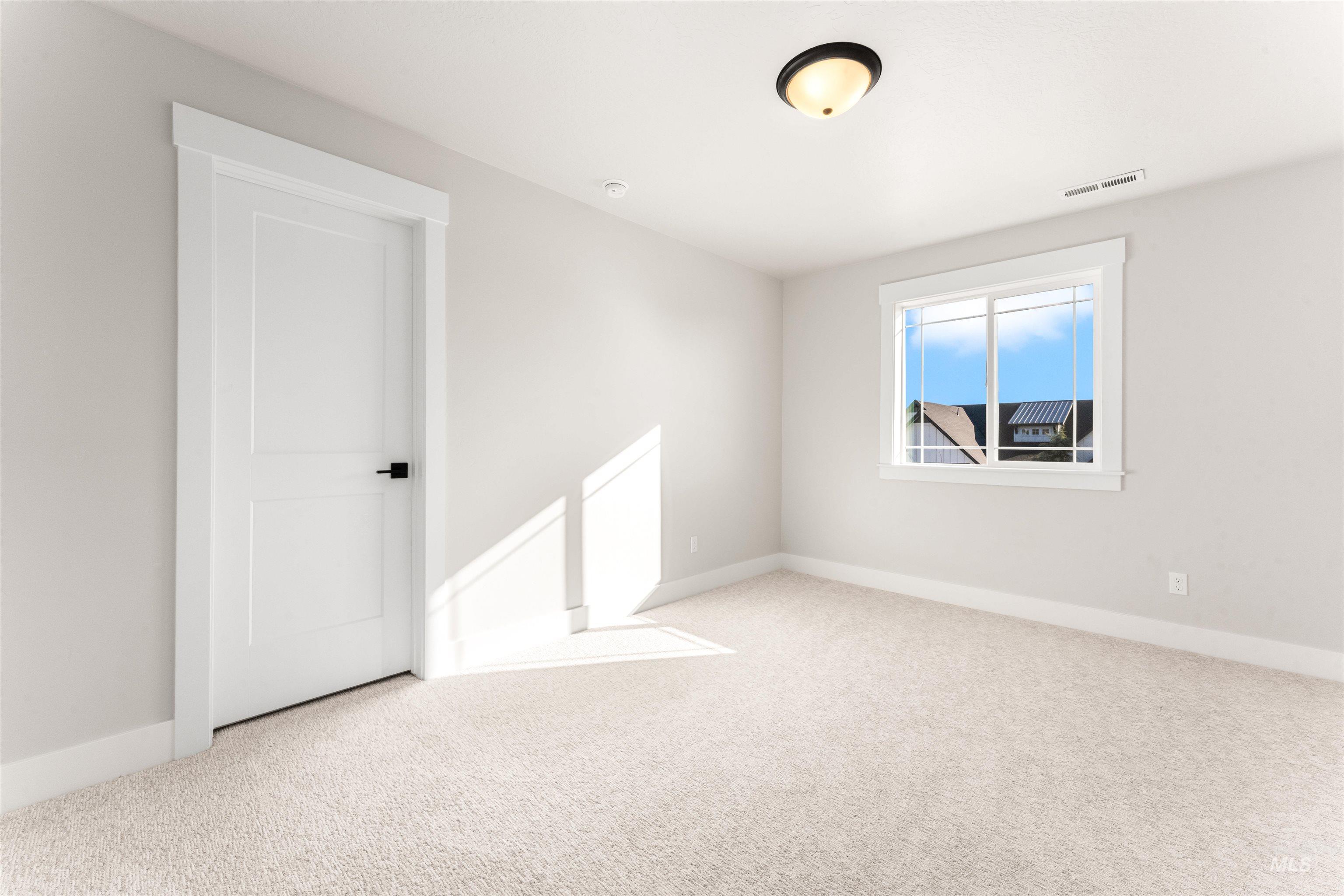 8084 Tandy Cv Street Middleton, ID 83644 - Photo 32 of 46 Empty room with light carpet and baseboards